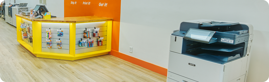 Oh Ship! counter with printing and scanning equipment, ready for documents and deliveries.