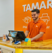 Oh Ship! employee assisting customer at counter in Tamarac, Florida.
