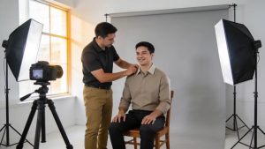 Professional photographer helping a customer with passport photo in a bright Tamarac studio